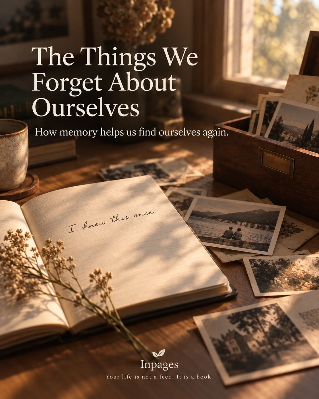 An open journal beside a box of old photographs and memories